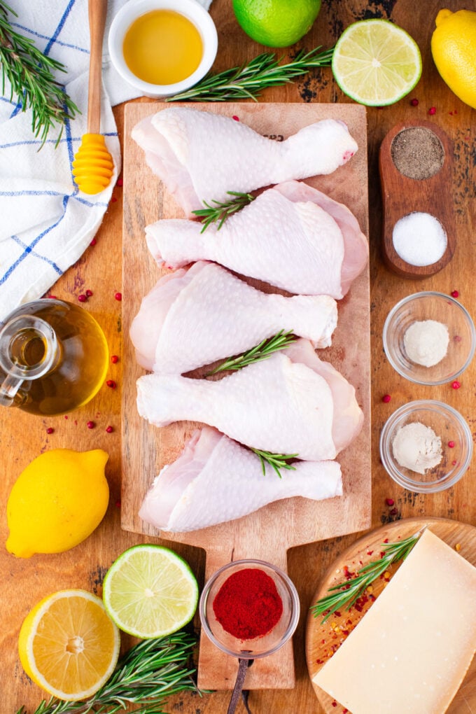 Overhead shot of crispy baked chicken legs ingredients arranged on a wooden surface.