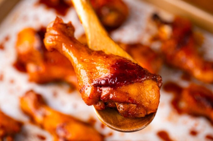 Overhead shot of crispy baked chicken leg on a serving spatula.