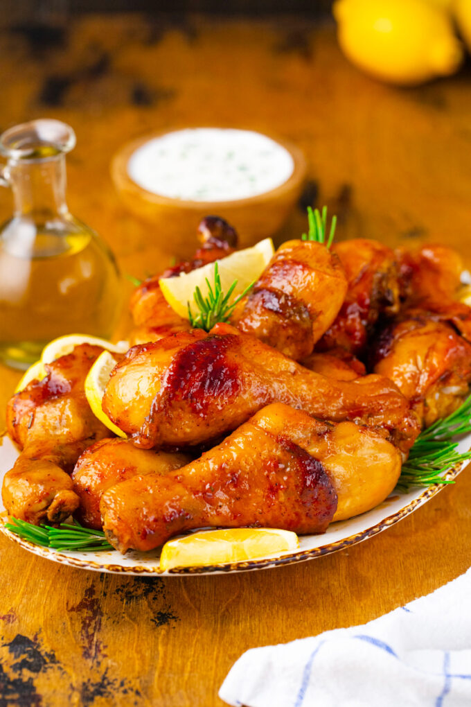 A serving plate with crispy baked chicken legs.
