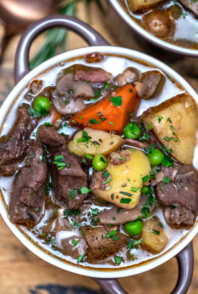 bowl of lamb stew with potatoes, sweet peas, and carrots