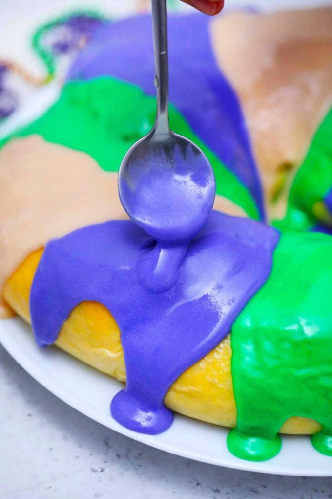 image of adding glaze to Mardi Gras king cake