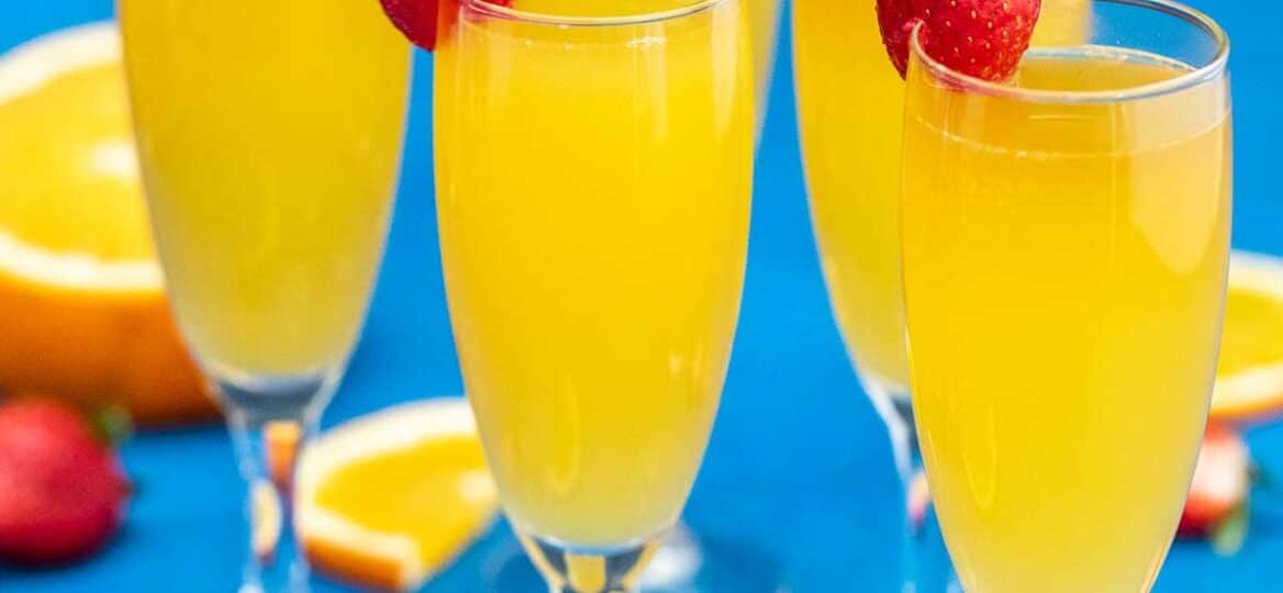 image of flutes of mimosas garnished with fresh strawberries