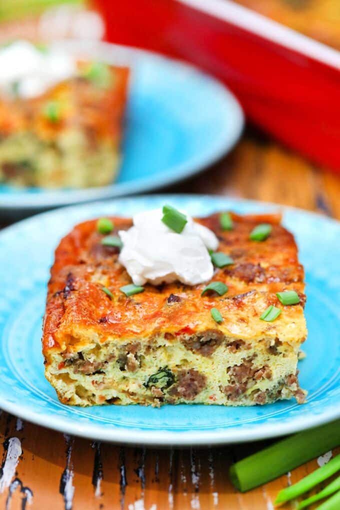 A slice of sausage breakfast casserole on a dish. 