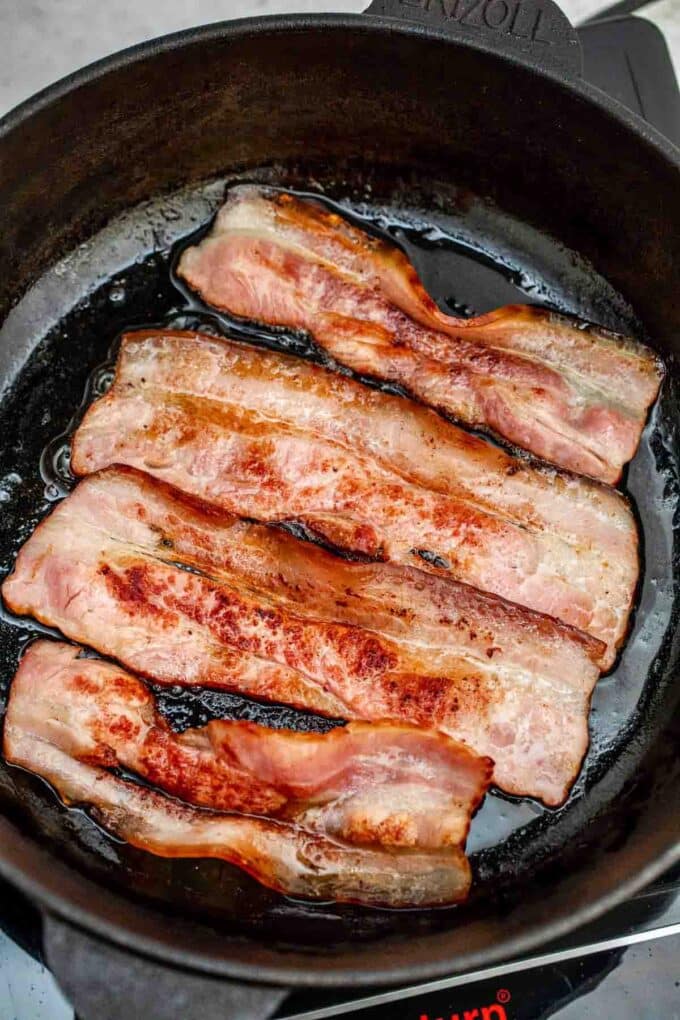 cooking bacon in a cast iron skillet