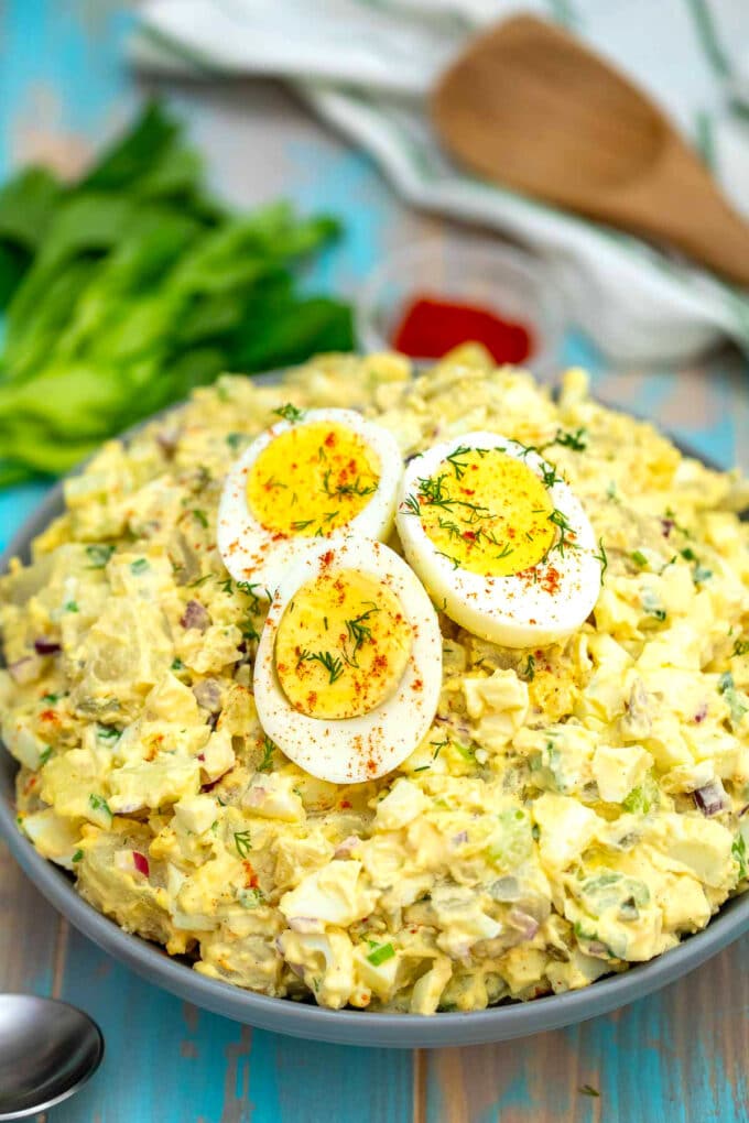 a bowl of Deviled egg potato salad topped with 3 egg halves