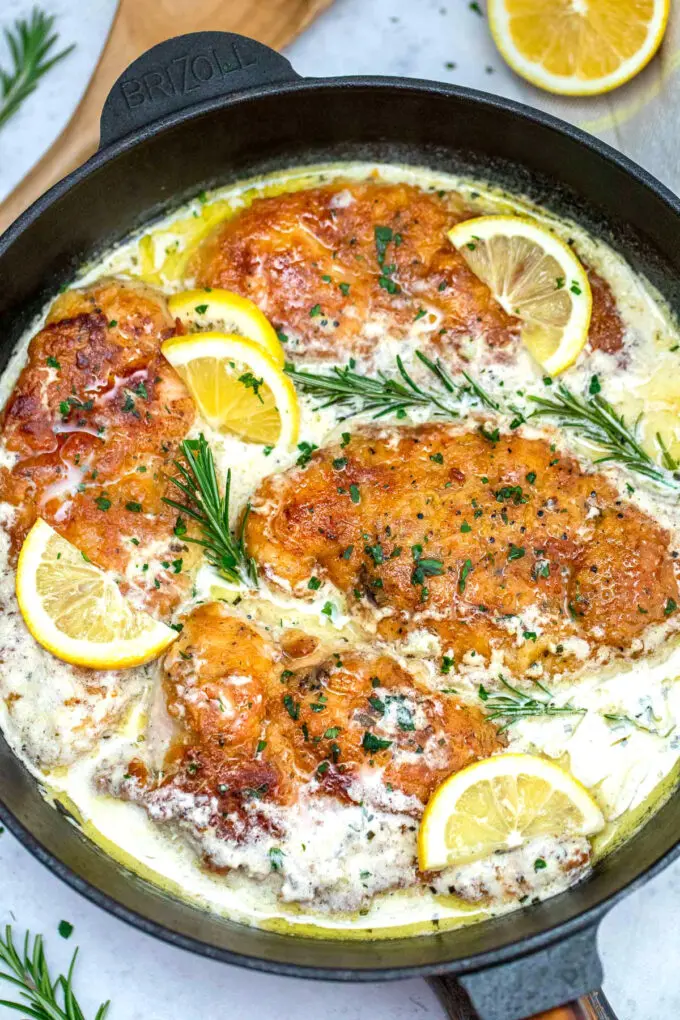 Image of cooked chicken francese in a pan with creamy sauce.