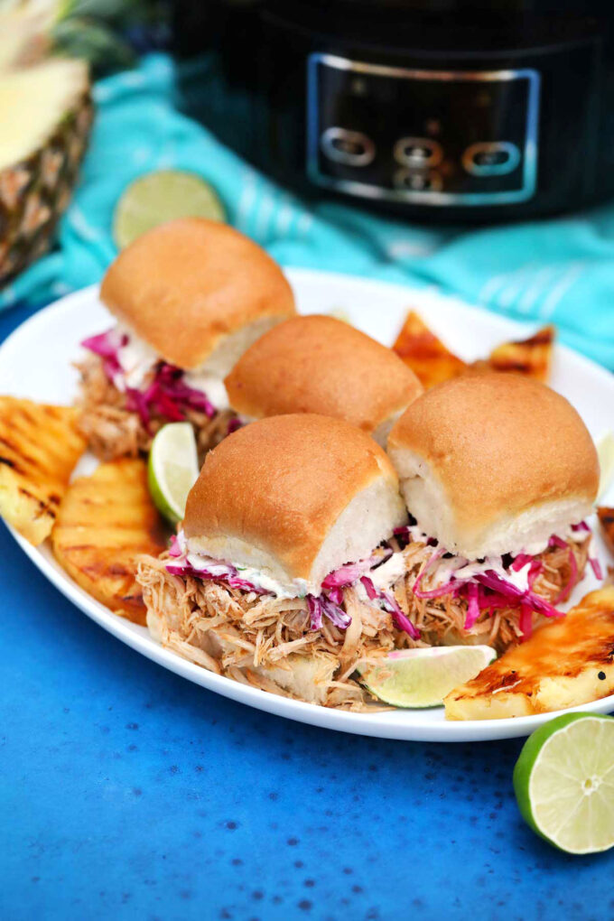 Photo of crockpot carnitas sliders on a serving plate.