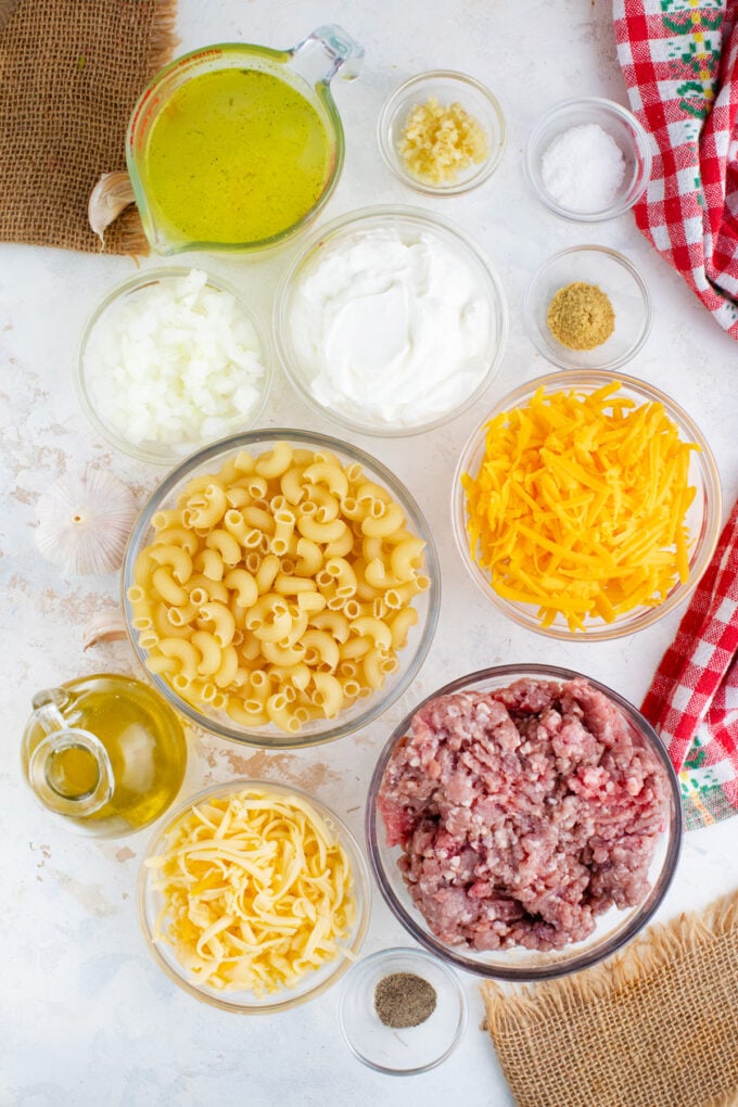 Overhead shot of Instant Pot cheeseburger macaroni ingredients in bowls on a table.
