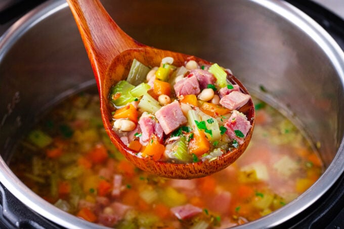A ladle of Instant Pot ham and bean soup.