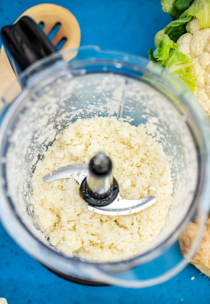 Pulsing cauliflower florets in a food processor.