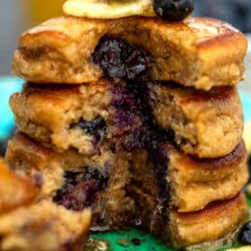 Picture of blueberry oatmeal pancakes topped with banana slices.