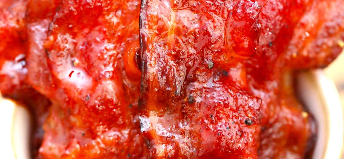 Image of homemade candied bacon in a white bowl.