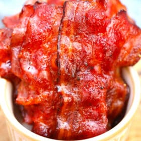 Image of homemade candied bacon in a white bowl.