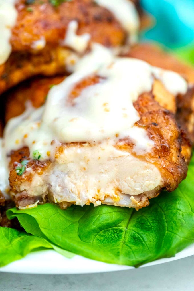 Image of baked chicken thigh with creamy sauce..