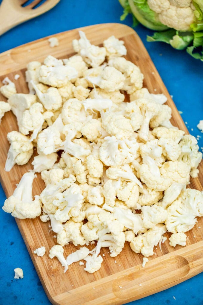 Chopped cauliflower on a cutting board.