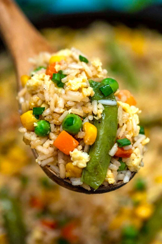 Image of a spoon full of egg fried rice.