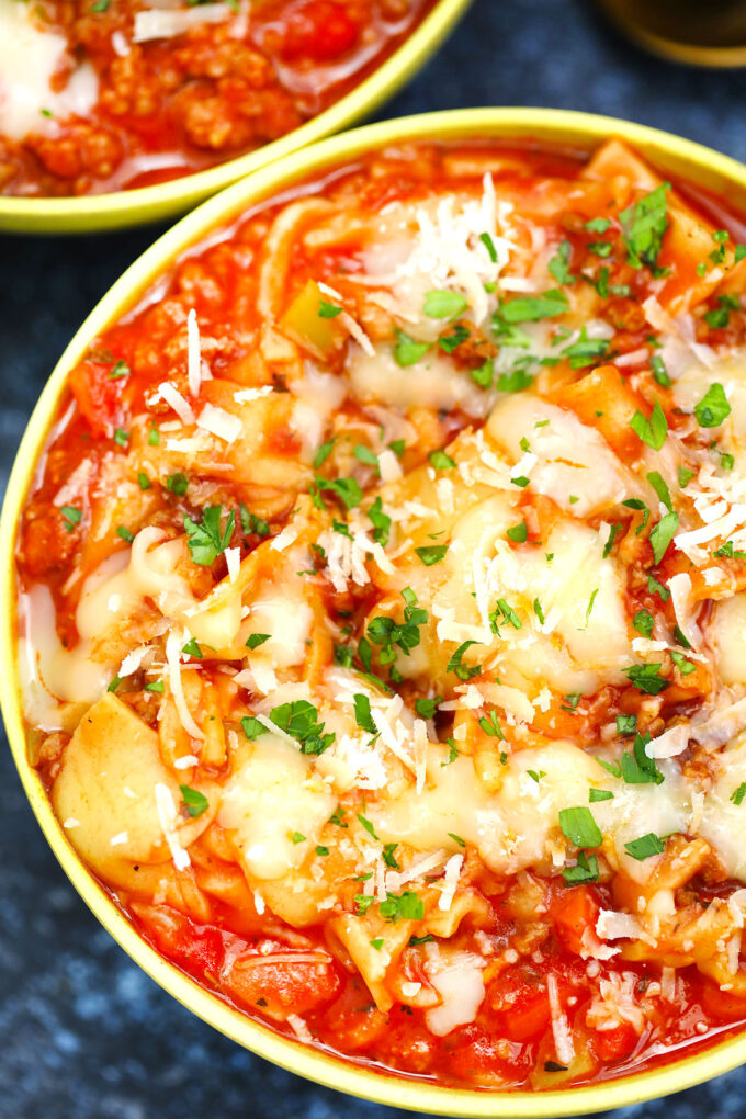 Image of crockpot lasagna soup topped with cheese.