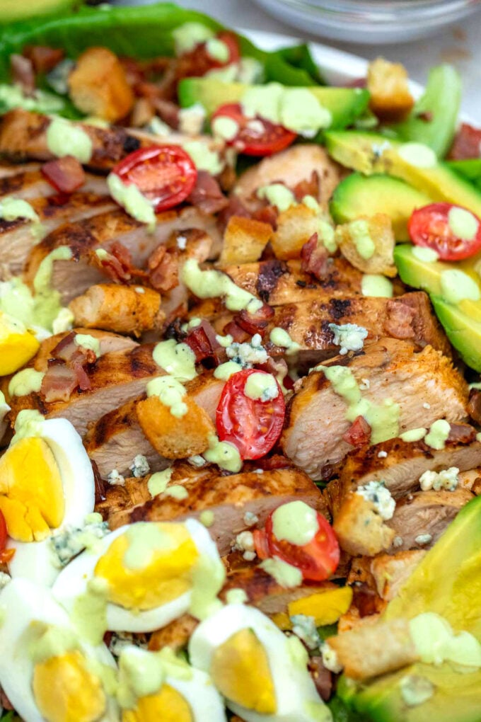 Homemade salad made with grilled chicken, hard boiled eggs, avocado, tomatoes, and lettuce.