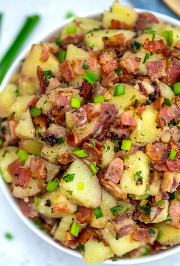 Image of German potato salad with bacon and green onions.