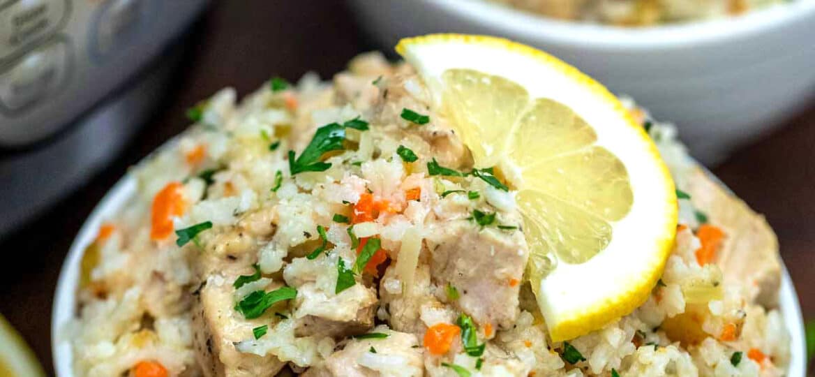 Image of lemon instant pot chicken and rice in a white bowl.