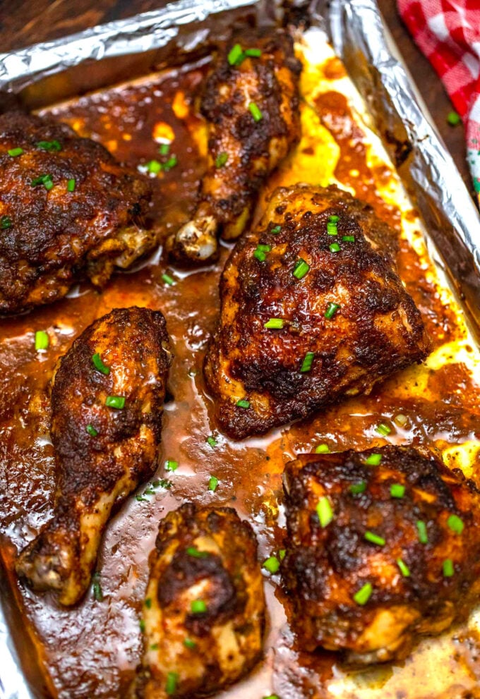 baked jerk chicken thighs on a baking sheet