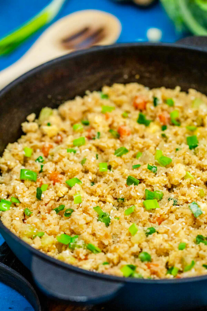 Low carb cauliflower rice in a cast iron skillet.