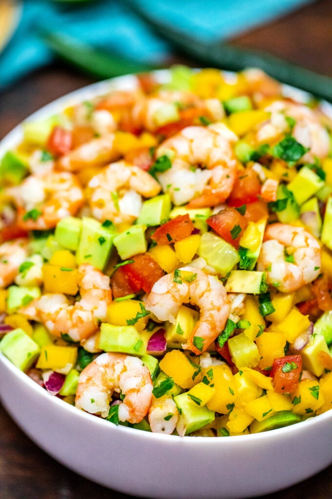 A bowl of shrimp ceviche with mango and avocado.