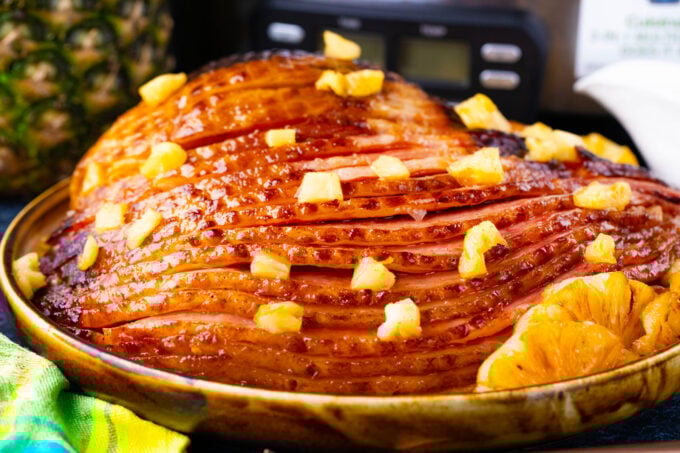 Homemade slow cooker pineapple ham on a serving plate.