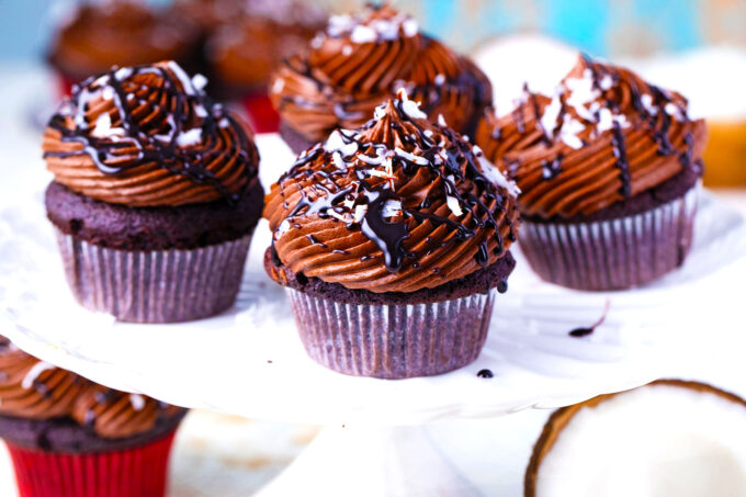 German chocolate cupcakes arranged on a cake stand.