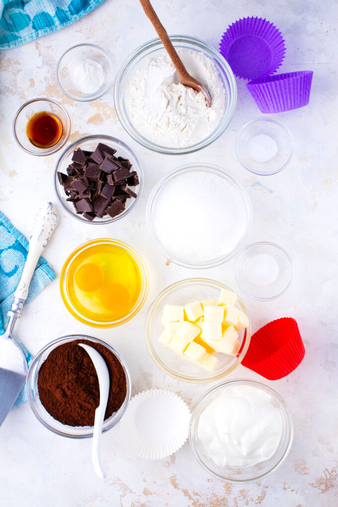 German chocolate cupcakes ingredients in bowls on a white surface.