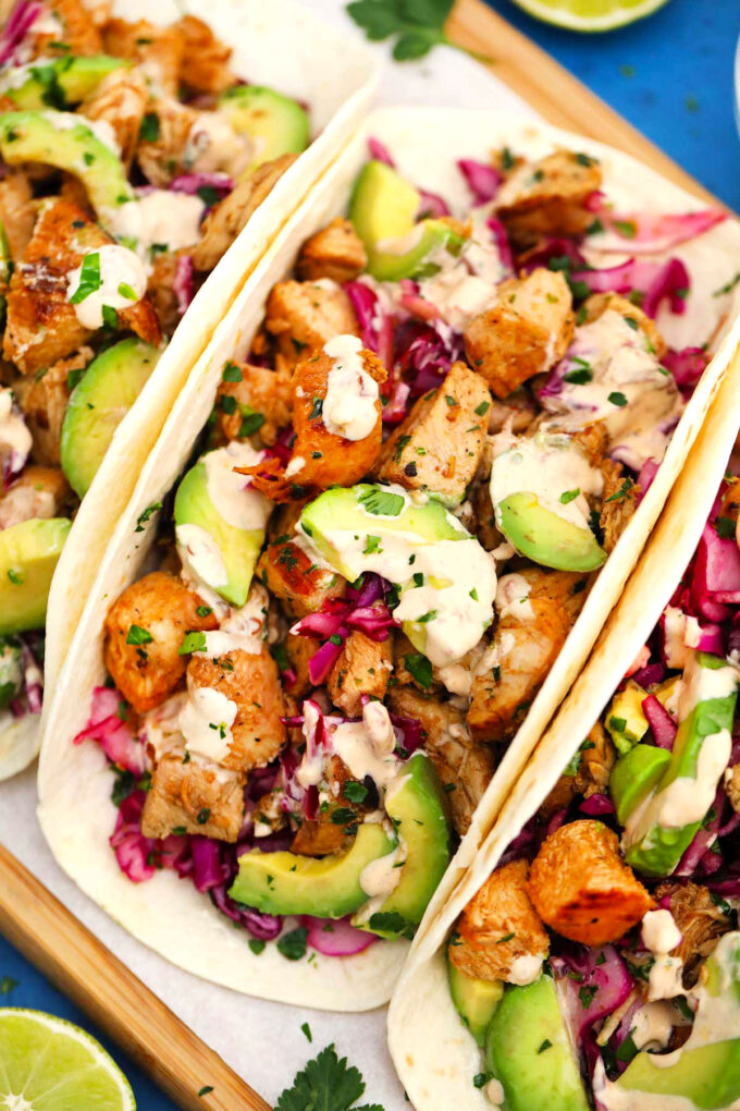 Chipotle chicken tacos with avocado and red cabbage slaw