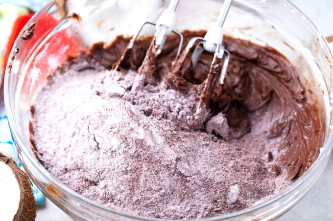 Mixing chocolate buttercream in a bowl.