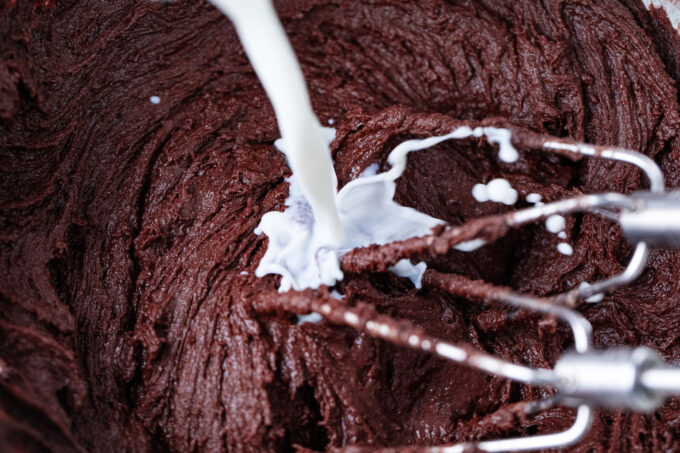 Adding milk into instant pot chocolate muffins batter.