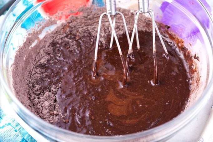 Whisking German chocolate cupcakes batter in a bowl.