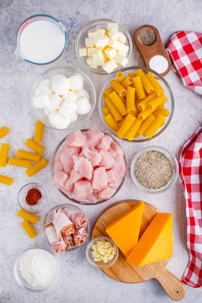 Overhead shot of crack chicken baked ziti ingredients in bowls on a table.