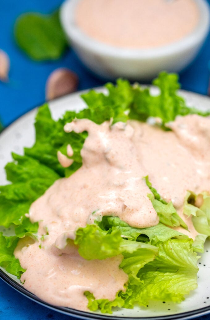 Image of thousand island dressing over green salad.