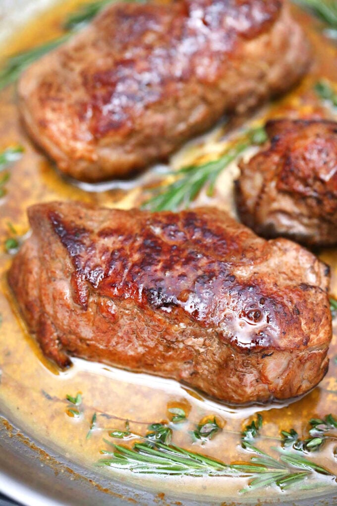 Image of pan seared steak in a butter sauce.