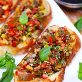 Photo of tri color tomato bruschetta.