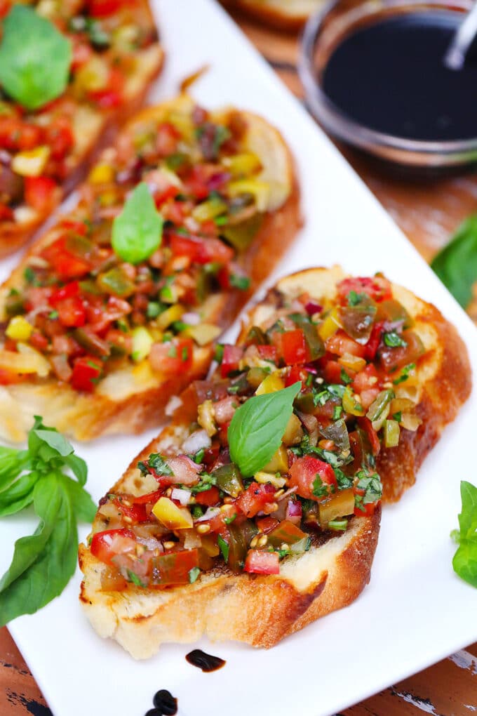 Photo of tri color tomato bruschetta.