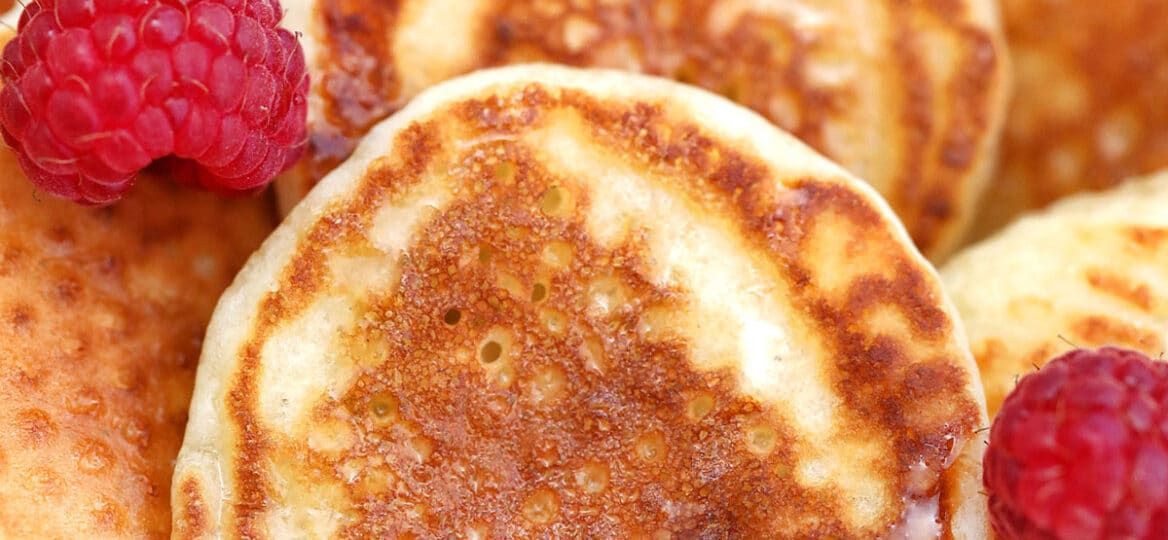 Image of silver dollar pancakes with raspberries.