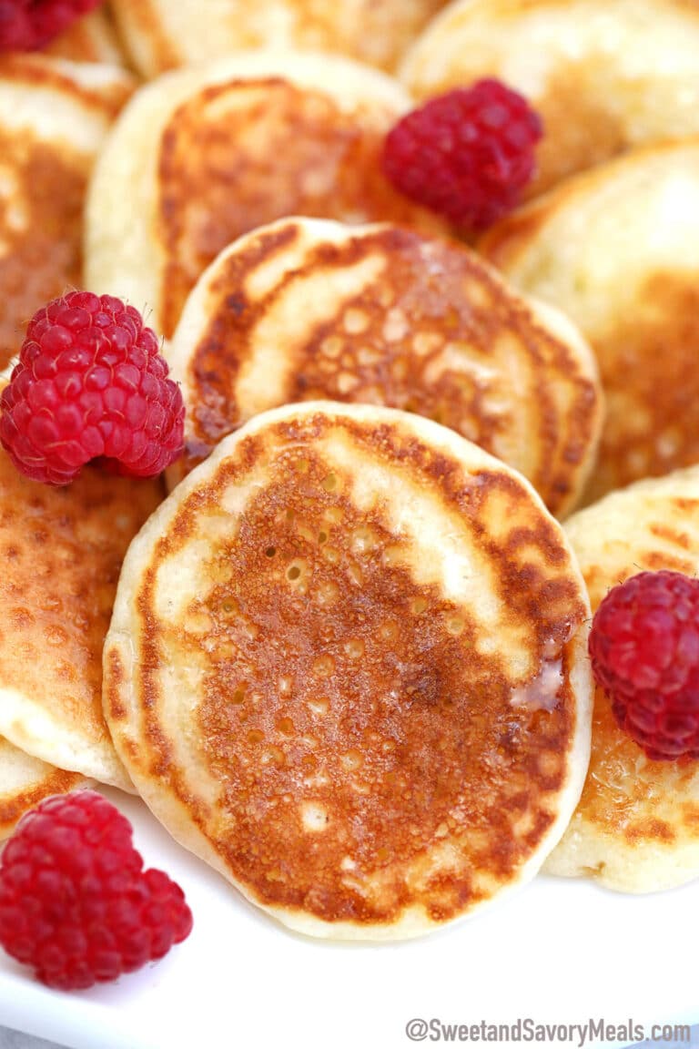 Image of silver dollar pancakes with raspberries.