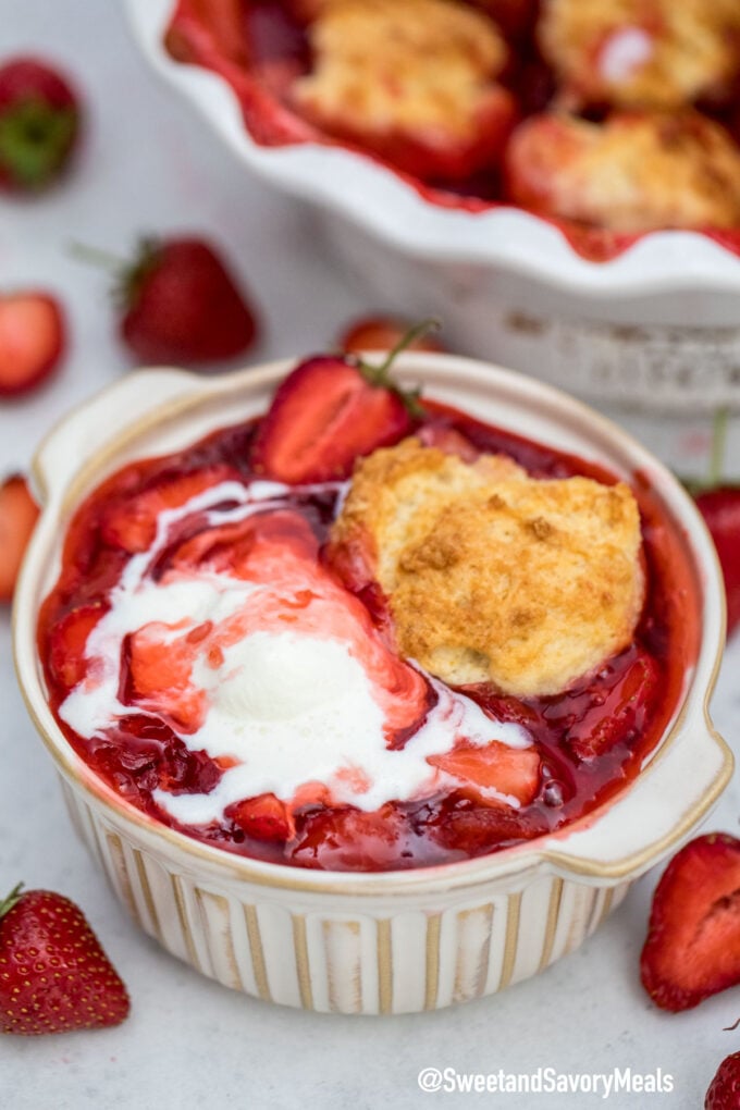 Photo of strawberry cobbler with ice cream.
