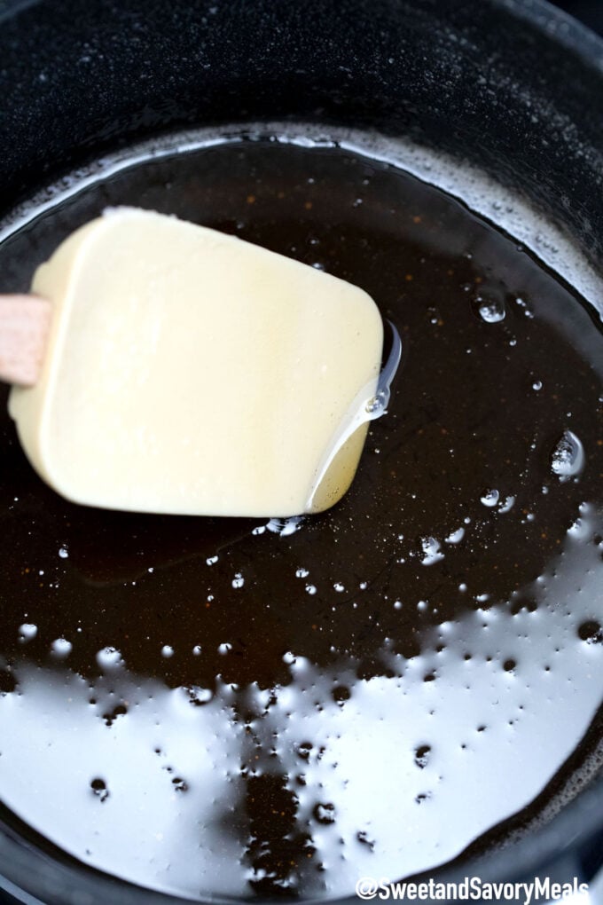 stirring golden syrup is a saucepan with a white spatula