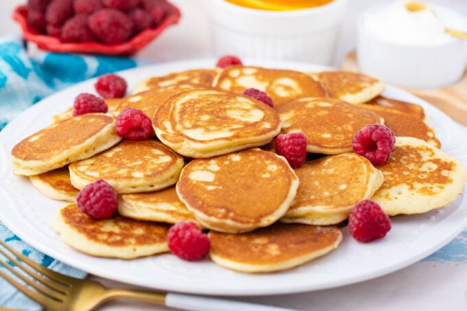 A plate of homemade golden silver dollars mini pancakes.
