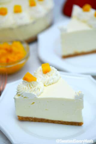 Photo of a slice of no bake mango cheesecake.