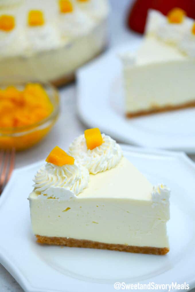 Photo of a slice of no bake mango cheesecake.