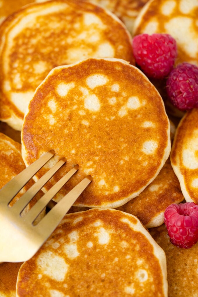 A fork piercing a mini pancake.
