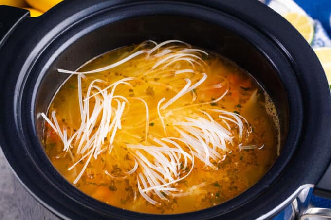 Adding rice noodles to crockpot Asian chicken noodle soup.