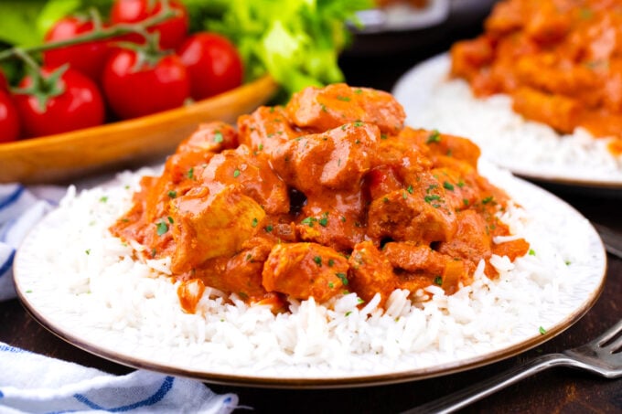 A plate of white rice with creamy slow cooker tikka masala.