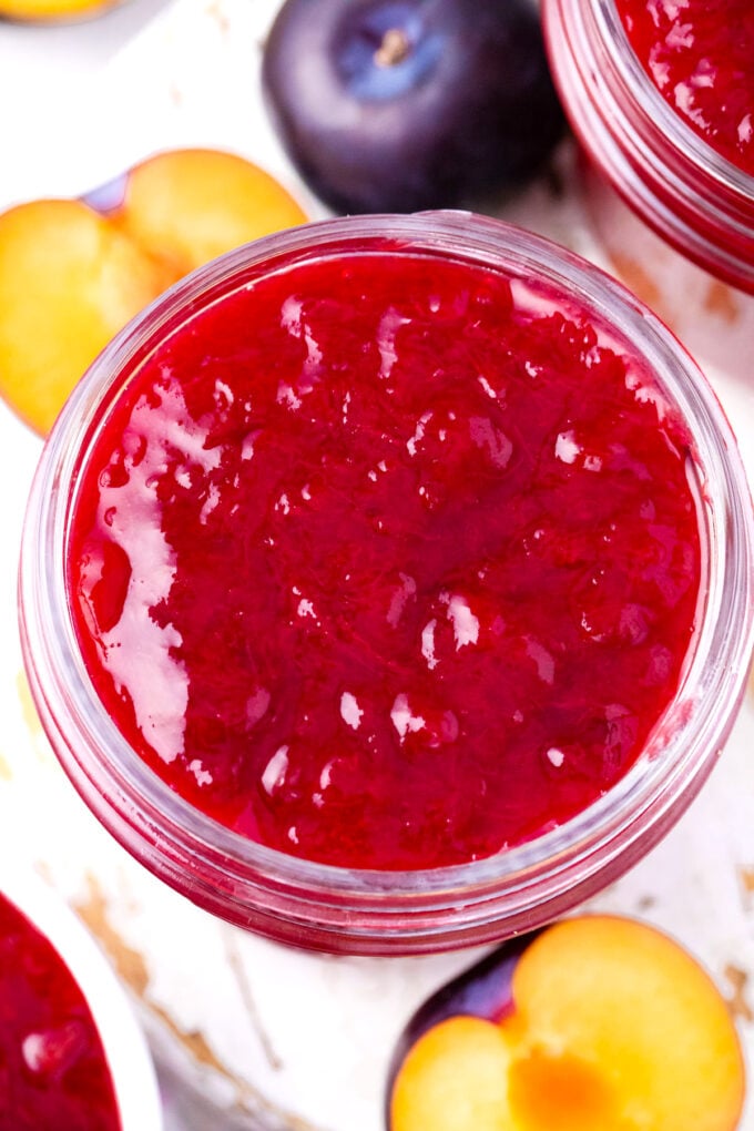 Overhead shot of a jar with plum jam.